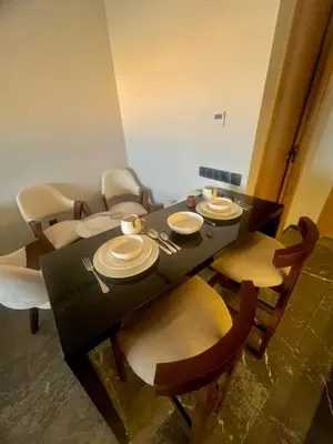 a dining room table with chairs and a black table at Appartement cosy près de Gueliz in Marrakech