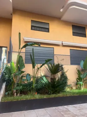a building with a bunch of plants in front of it at Appartement cosy près de Gueliz in Marrakech