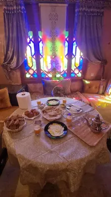 a table with plates of food on it with stained glass at Appartement Laila Guéliz - Victor Hugo in Marrakech