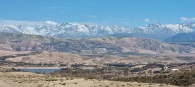 a mountain range with a lake and snow covered mountains at Appartement Laila Guéliz - Victor Hugo in Marrakech