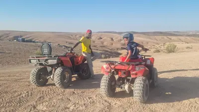 two people are riding atvs in the desert at Appartement Laila Guéliz - Victor Hugo in Marrakech