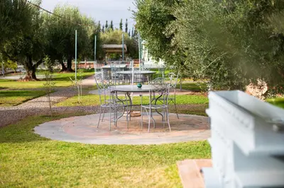 a table and chairs sitting in a park at Ferme dhôte Sidi Safou Cabane en bois Marrakech in Marrakech