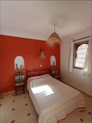a bedroom with red walls and a large bed at Villa MyMa in Marrakech