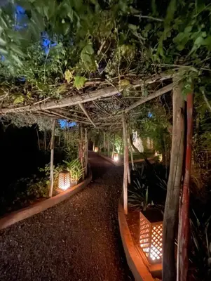 a pergola with lights in a garden at night at Villa MyMa in Marrakech