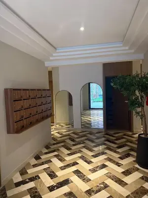 a lobby with a checkered floor and a doorway at Résidence haut standing Piscine Fitness Marrakech in Marrakech