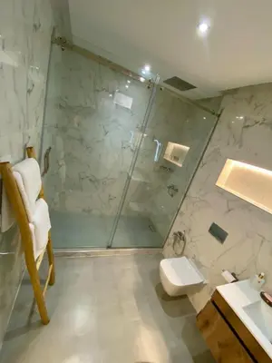 a bathroom with a shower and a toilet and a sink at Charmant cocon moderne in Marrakech