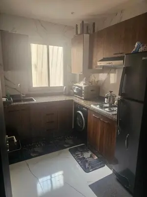 a kitchen with a mess on the floor and a refrigerator at مراكش in Marrakech