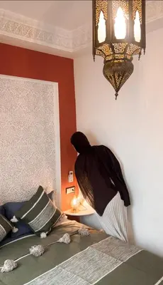 a room with a bed and a chandelier at Penthouse city center sdfghjhgfdsdfghjhgfdsdfghjhgfds in Marrakech