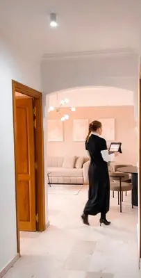 a woman in a black dress standing in a living room at Penthouse city center sdfghjhgfdsdfghjhgfdsdfghjhgfds in Marrakech
