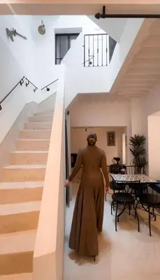 a woman walking up a staircase in a house at Penthouse city center asdfghjsasdfghjk in Marrakech
