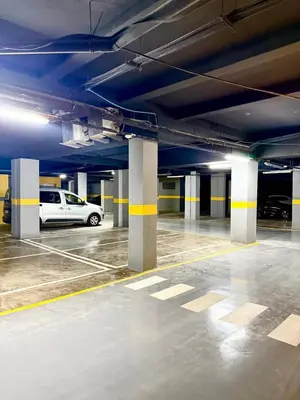 a parking lot with cars parked in a parking garage at Stylish and cozy accommodation for families in Marrakech
