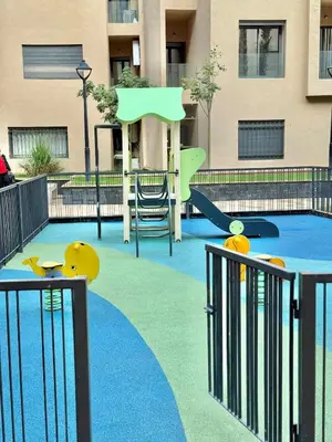 a playground with a skateboard in front of a building at Stylish and cozy accommodation for families in Marrakech
