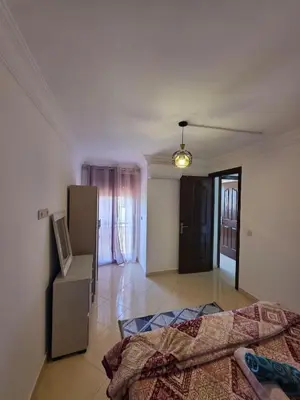 a bedroom with a bed and a television in it at Appartement Lady Plaza 3 in Marrakech