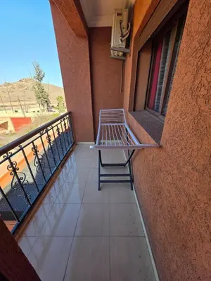 a bench sitting on the balcony of a building at Appartement Lady Plaza 3 in Marrakech