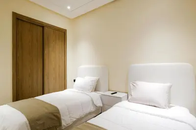 two beds sitting next to each other in a room at Appartement vacances famille Marrakech in Marrakech