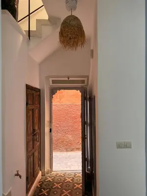 an empty hallway with a door and a window at Riad Mtiwel in Marrakech