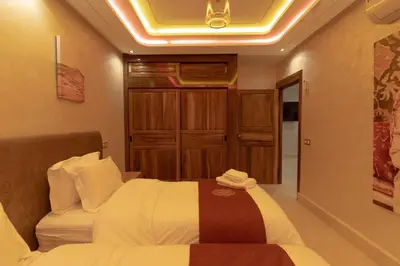 a hotel room with a bed and a closet at Gueliz Stay in Marrakech