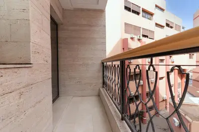 a balcony of a building with a metal railing at Gueliz Stay in Marrakech