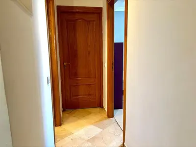 a hallway with a wooden door in a room at Cozy 2-bedroom apartment & pool & wifi in Marrakech