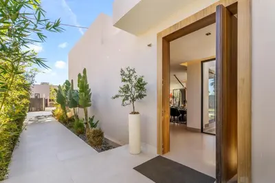 a pivot door in a house with plants at VILLA Twenty six 1600m2 Marrakech LUXE & PROXIMITÉ in Marrakech