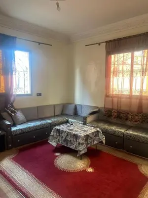 a living room with a couch and a table at modern apartment, 10 minutes from the airport in Oulad Akkou