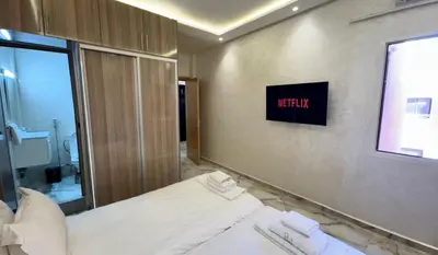 a hotel room with a bed and a mirror at Appartement cozy in Marrakech
