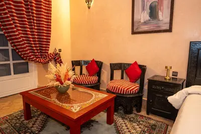 a living room with two chairs and a coffee table at Mumtaz Dar in Marrakech
