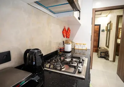 a kitchen with a stove top oven in a kitchen at Oasis Urban & Balcon - 5 min de l'aeroport in Marrakech