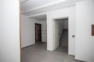 an empty hallway with stairs and white walls at Oasis Urban & Balcon - 5 min de l'aeroport in Marrakech