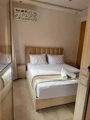 a bedroom with a large bed with white pillows at Location Centrale - Heated 1BR - Parking - Netflix in Marrakech
