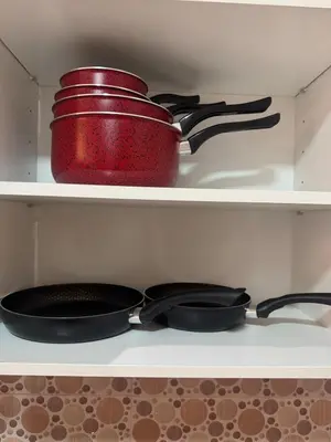 a red pot and pans sitting on a shelf at Location Centrale - Heated 1BR - Parking - Netflix in Marrakech