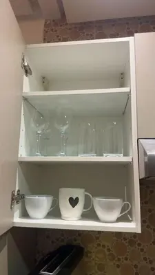 a white cabinet with wine glasses and bowls at Location Centrale - Heated 1BR - Parking - Netflix in Marrakech