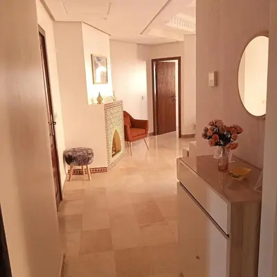 a hallway with a living room with a table and chairs at Your chic retreat under the Marrakesh sun in Marrakech