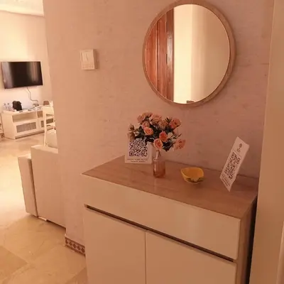 a vase of flowers on a counter with a mirror at Your chic retreat under the Marrakesh sun in Marrakech