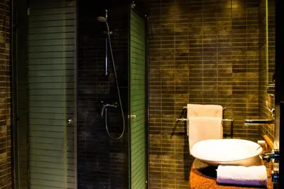 a bathroom with a shower with a toilet and a sink at Chambre double Standard in Marrakech