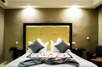 a bedroom with a large bed with pillows at Chambre double Standard in Marrakech