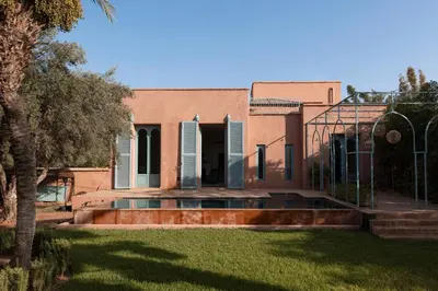 a house with a pool in the yard at Riad Johara Marrakech in Marrakech