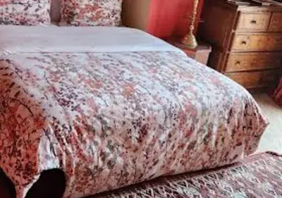 a bedroom with a bed with a floral bedspread at Private villa Marrakech in Marrakech