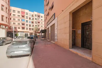 a car parked on a sidewalk next to a building at 2 King Suites 2 Living Rooms 3 min Gueliz Carre Eden in Marrakech