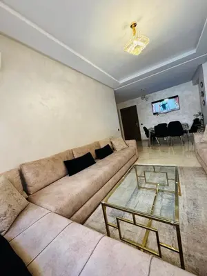 a living room with a couch and a glass table at Elegant City Apartment in Marrakech