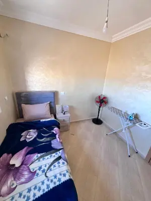 a bedroom with a bed and a tripod in a room at Apartmen rentals with M Z in Oulad Akkou