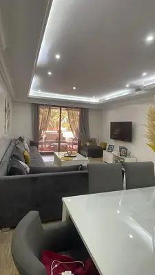 a living room with a couch and a table at Résidence Soltana in Marrakech