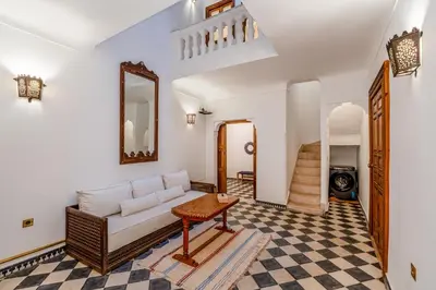 a living room with a couch and a table at Riad Lalla Rachida in Medina Heart Of Marrakech B&B in Marrakech