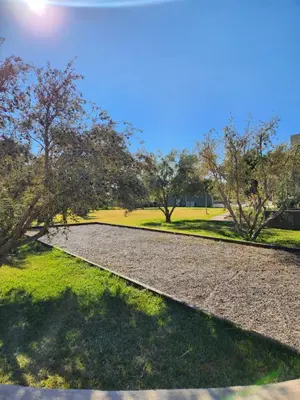 a walkway in a park with trees and grass at Atlas villa c3 in Sraghna
