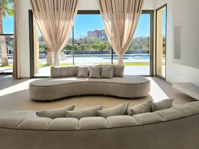 a large couch in a living room with large windows at Atlas villa c3 in Sraghna