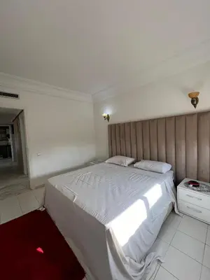 a bedroom with a large bed with white sheets at Marakech Giliz Atlas in Marrakech