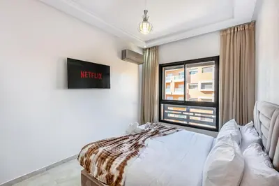 a bedroom with a bed and a window at Modern Gueliz, Hivernage City Centre 2 Bedroom Apartment in Marrakech