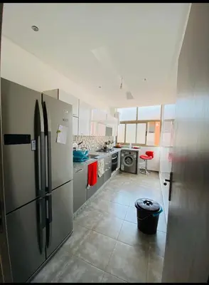 a kitchen with stainless steel refrigerators and a kitchen with at Sweet home in Marrakech