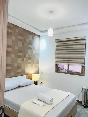 a bedroom with two beds and a window at Sweet home in Marrakech