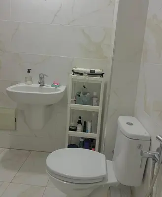 a white bathroom with a toilet and a sink at Sweet home in Marrakech